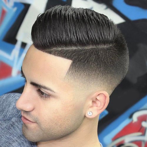 A boy is looking downward and showing his Comb Over + Curved Razor Part hairstyle - hairstyle for boys