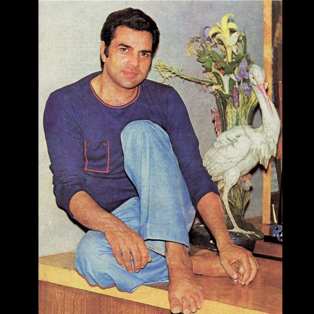 Dhaemendra in Dark blue full sleeves t-shirt and light blue jeans sitting - most handsome man in India 2021