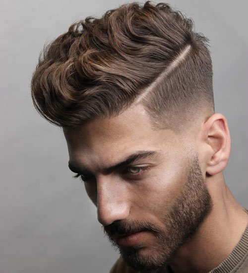A boy in grey shirt showing his Wavy Quiff + Short Beard hairstyle - hairstyles for boys short hair