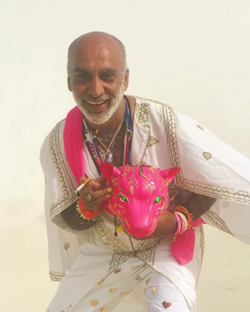 Designer Manish Arora smiling and posing for camera with pink panther toy - gay fashion designers