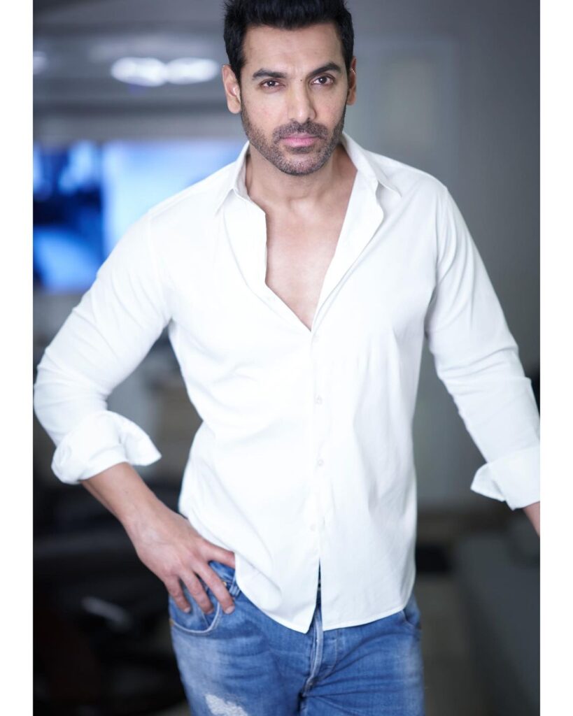 John Abraham posing for camera in white shirt - most popular actor in bollywood