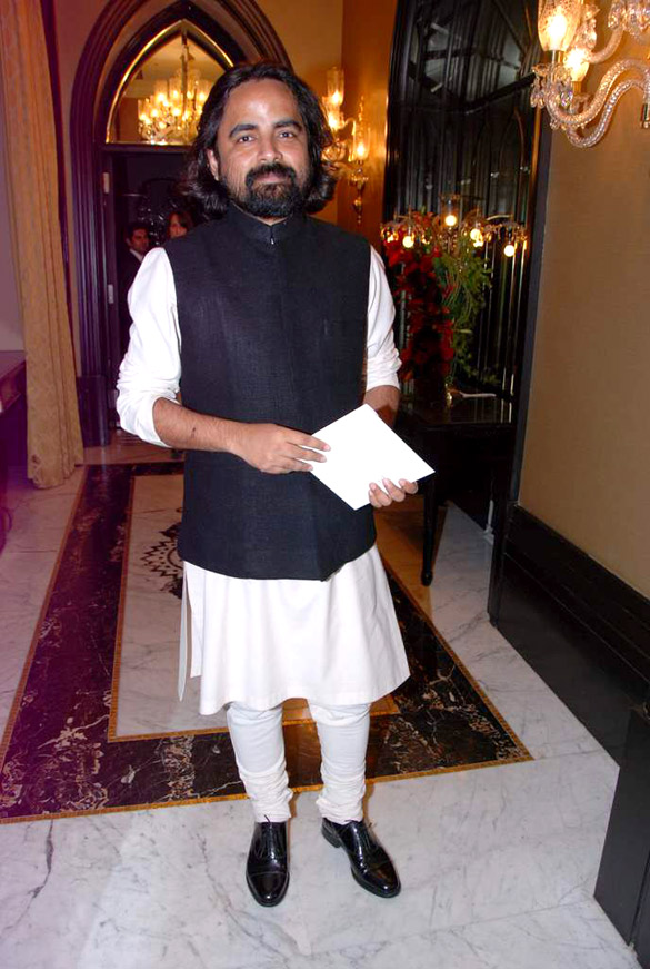 Sabyasachi Mukherjee standing in white kurta pajama with black Nehru jacket -  gay celebrities India