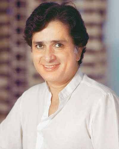 Smiling Shashi Kapoor in white kurta posing for camera - most handsome bollywood actors of India