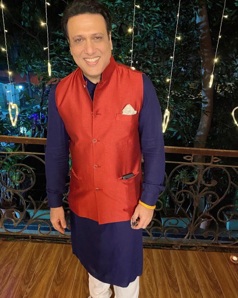 Govinda in Blue Kurta and red half jacket posing for Camera - bollywood short actors