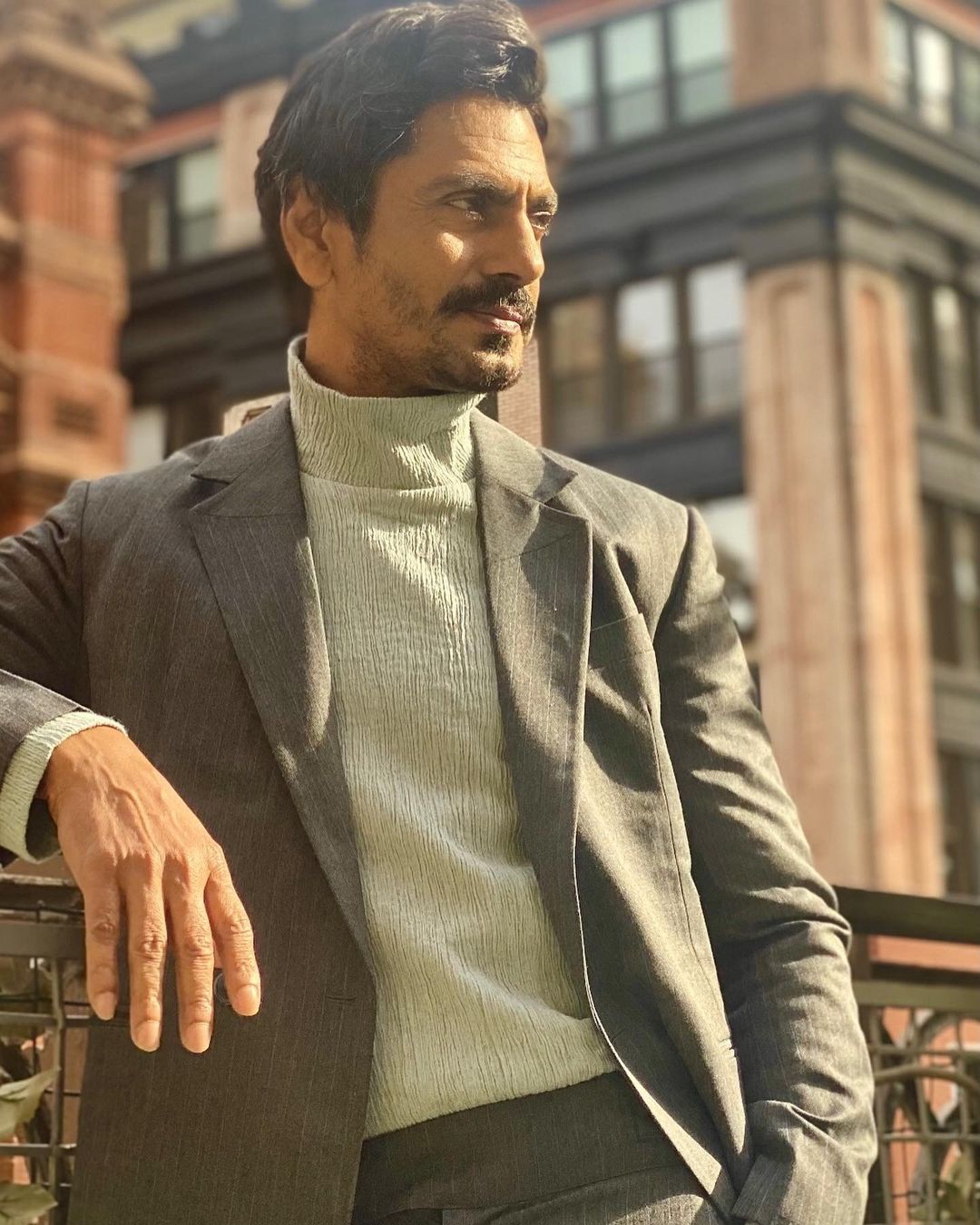 Nawazuddin Siddiqui  in grey jacket and off white high neck inner posing for camera - list of short actors