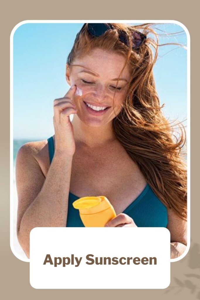 A girl in blue top applying sunscreen on her cheek -  acne prone skin meaning