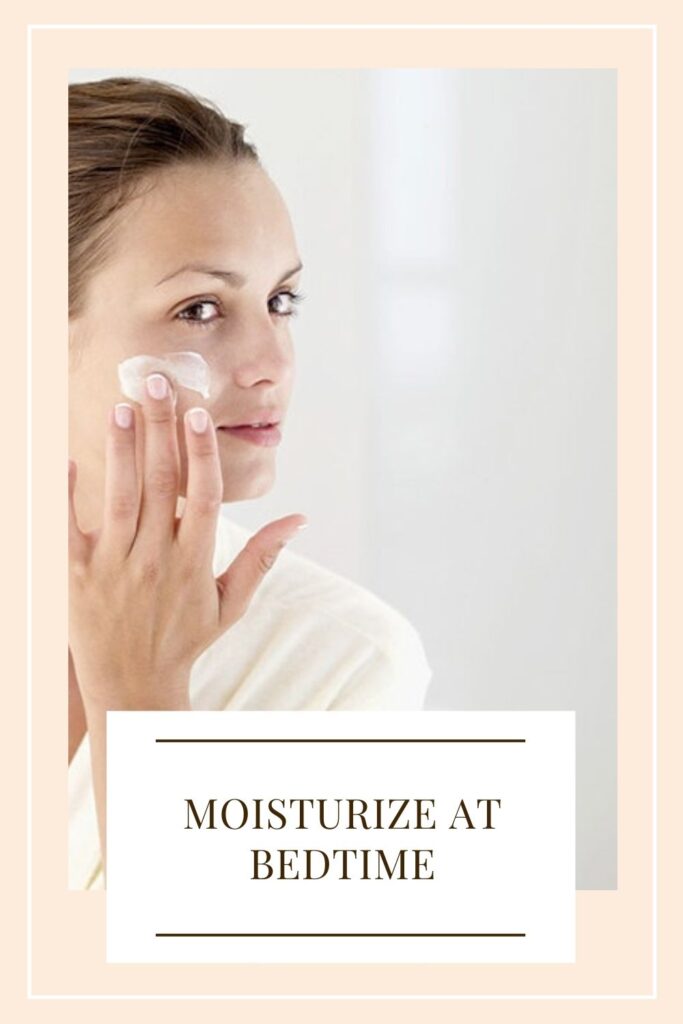 A girl is applying moisturizer on her face - winter skin care routine