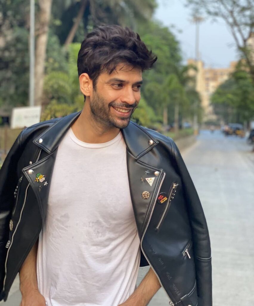 Gaurav Arora in white t-shirt and black leather jacket posing for camera - top models in India