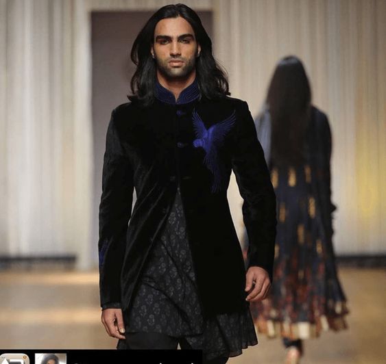 Mohit Nandal in black long jacket walking on a ramp - male models in India