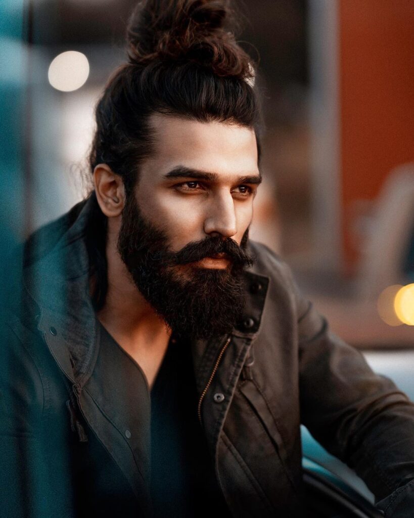 Nitin Chauhan in black jacket posing for camera - models in India 2022