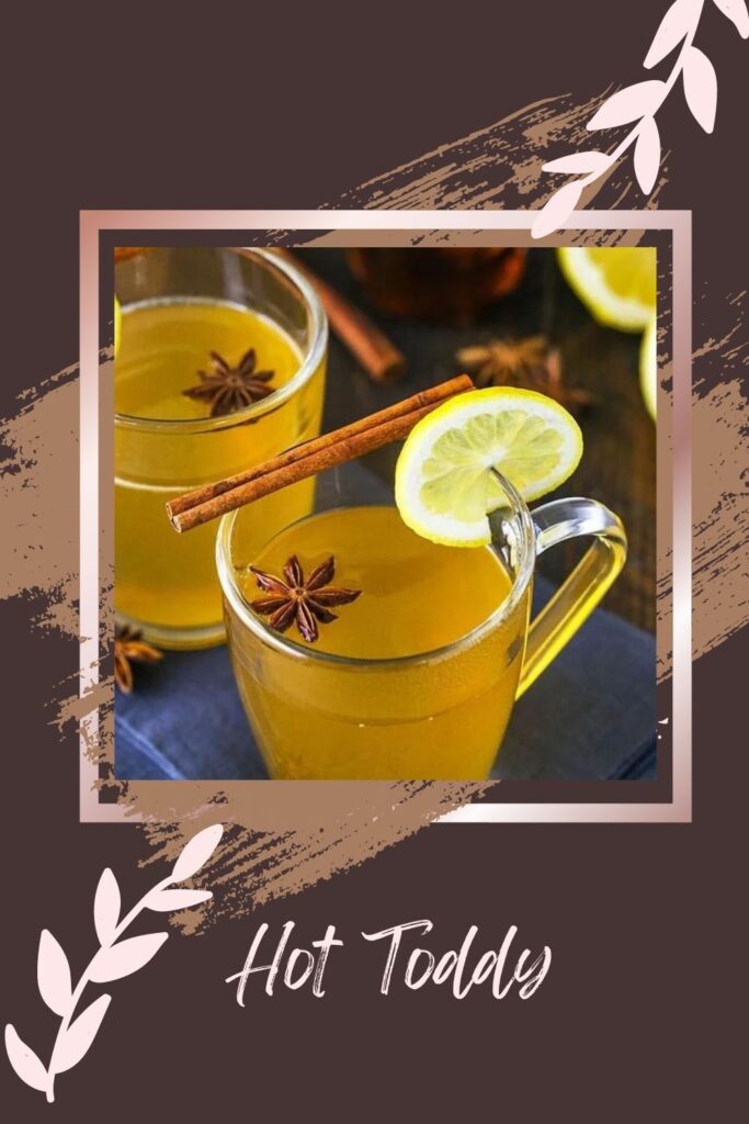 Hot Toddy served in a transparent cup with lemon and cinnamon stick - drink for glowing skin
