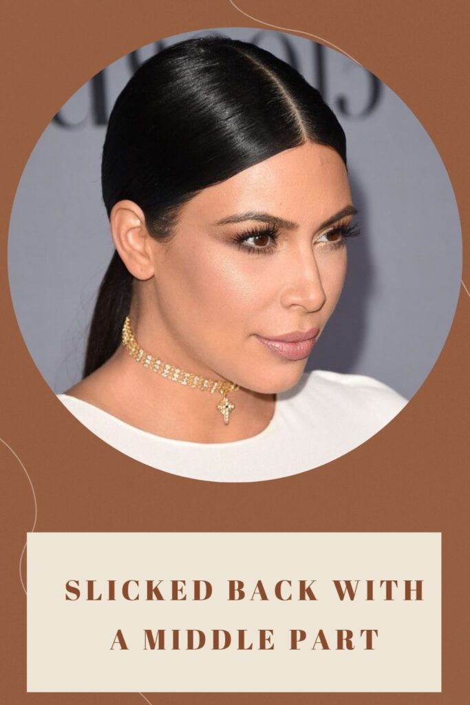 Kim Kardashian is posing with Slicked Back with a Middle Part hairstyle - hairstyles for round face