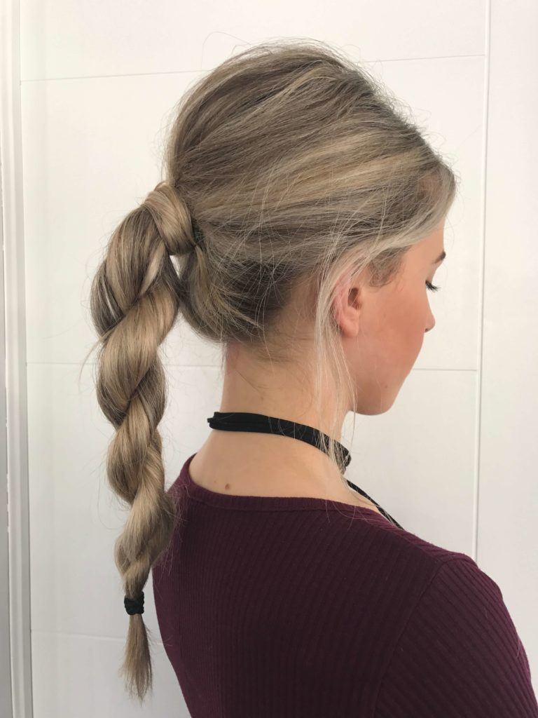 A girl in marron top showing her Rope braid ponytail - hairstyles for long hair