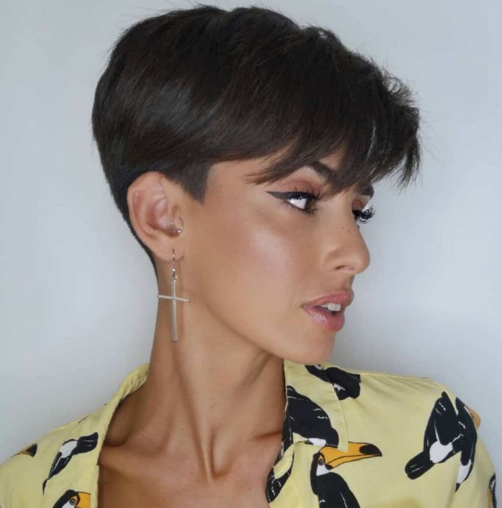 a girl in black and beige shirt posing for camera and showing her pixie bob - hairstyle for women
