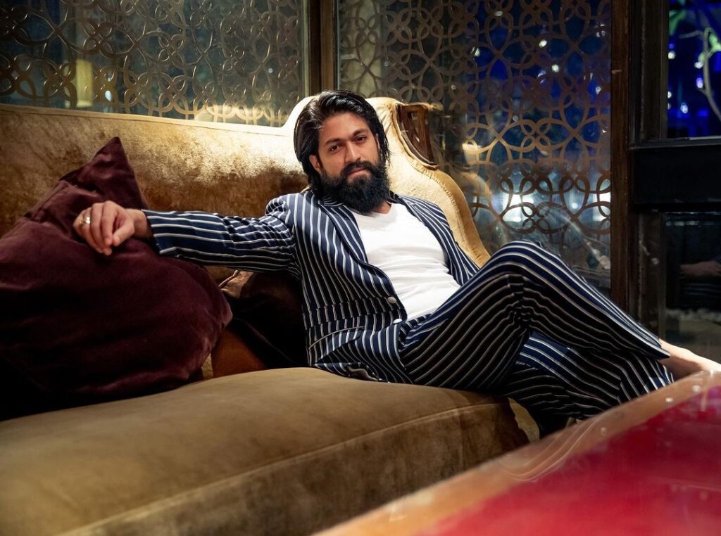 Yash sitting on a sofa in blue lining suit with white t-shirt and posing for camera - South Indian actors 