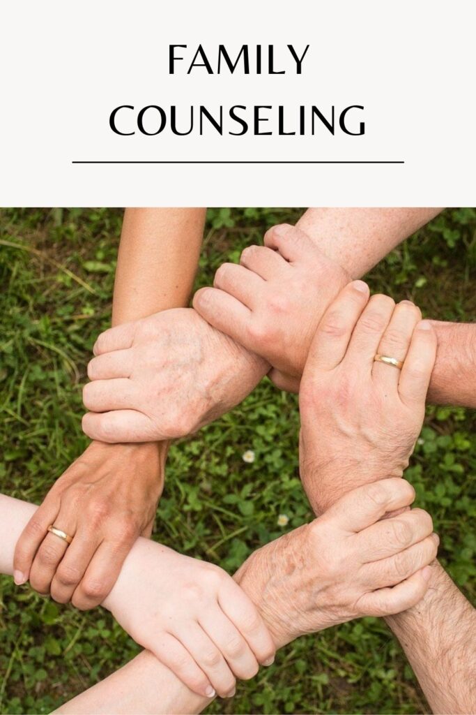 A family holding each other's hand - Family Therapy