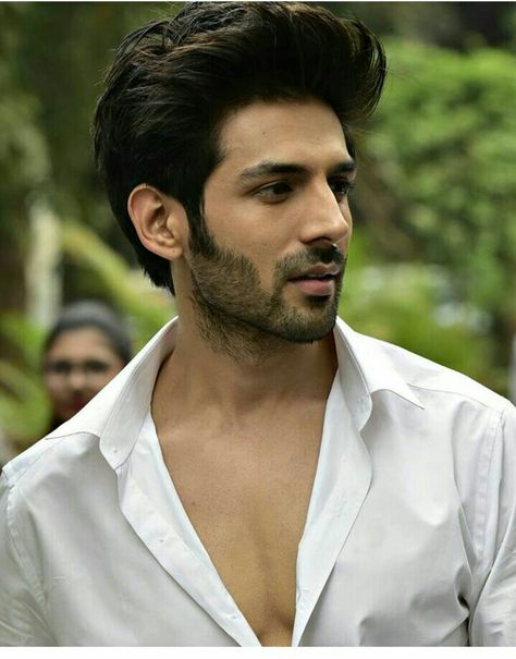 Kartik Aaryan in front open white shirt posing for camera and showing his quiff hairstyle - Bollywood Actors Latest Hairstyles
