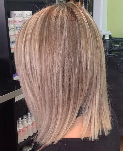 A girl in black top showing the back side of her pearl blonde hair color - blonde hair color ideas