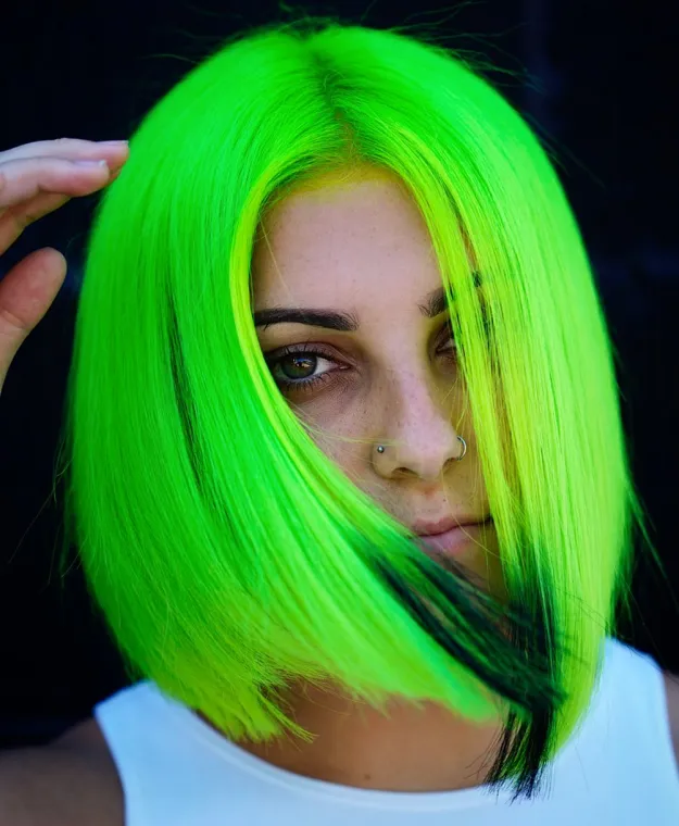 A girl is showing her Electric Lizard hair color - green hair color for women