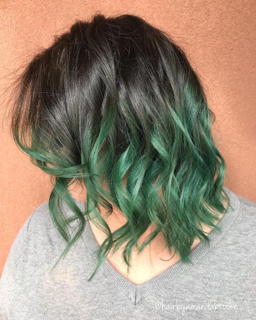 A girl in grey top showing the side view of her Black and Green Ombre Hair color - green hair color
