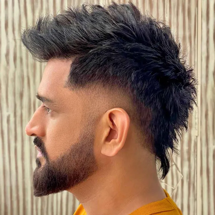 MS Dhoni in mustard yellow t-shirt showing the side view of his trendy faux hawk haircut and beard - hairstyles of MS Dhoni