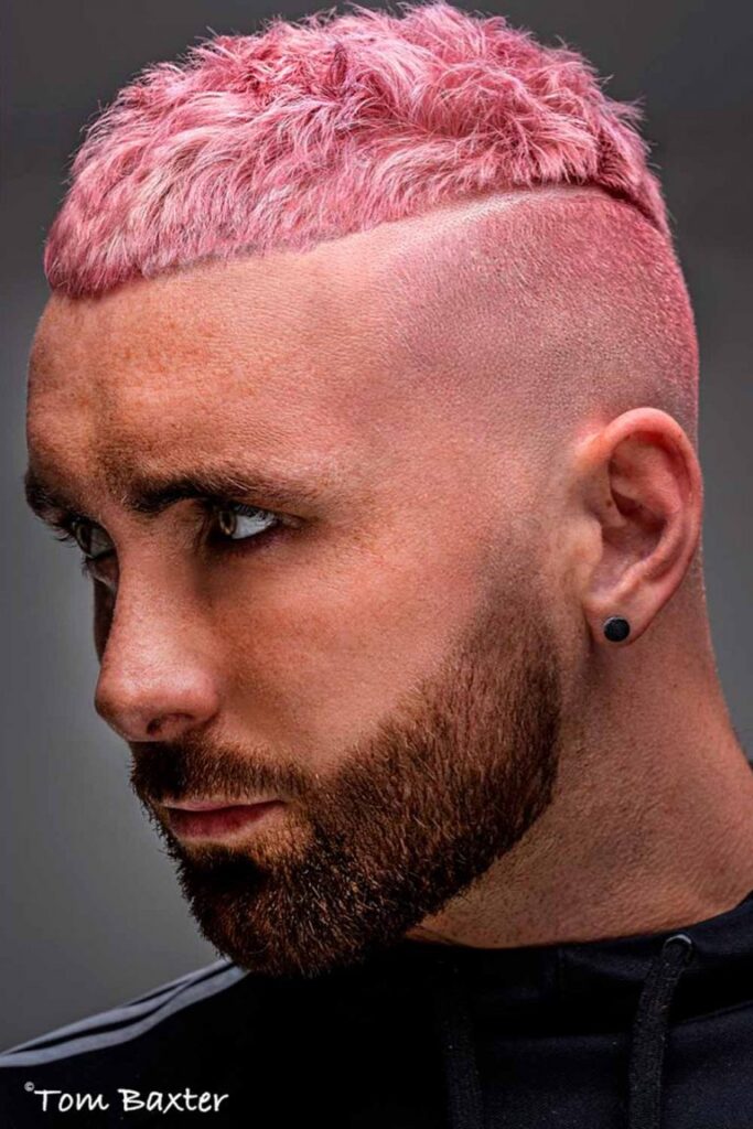 A man in black t-shirt with white strips showing his pink Textured High And Tight Haircut - men's haircut 2022