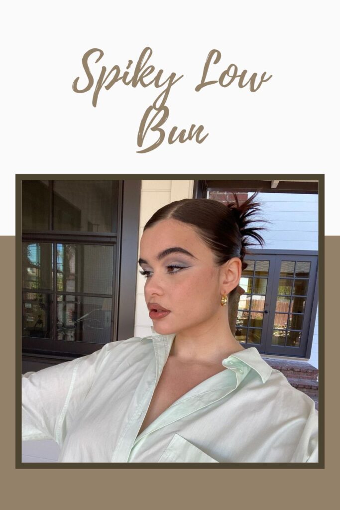 Beyaz önü açık gömlekli, cesur makyajlı, Spiky Low Bun saç stilini gösteren bir kız - en yeni kızın saç modeli