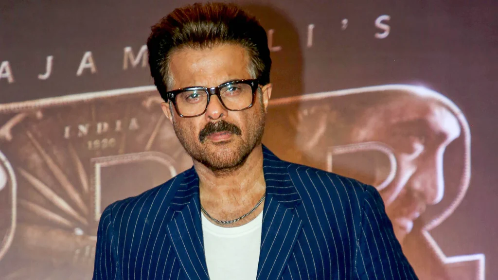 Anil Kapoor in Blue lining coat with white inner and spectacles posing for camera - bollywood hero without makeup photos 