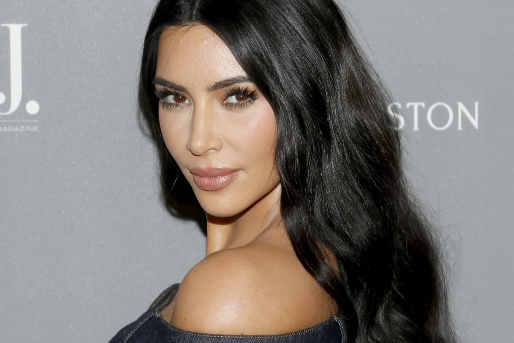 Kim Kardashian in black off shoulder dress with long open hair - celebrities who got lasik
