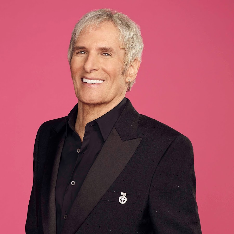Smiling Michael Bolton in all black suit - celebrities who got lasik surgery