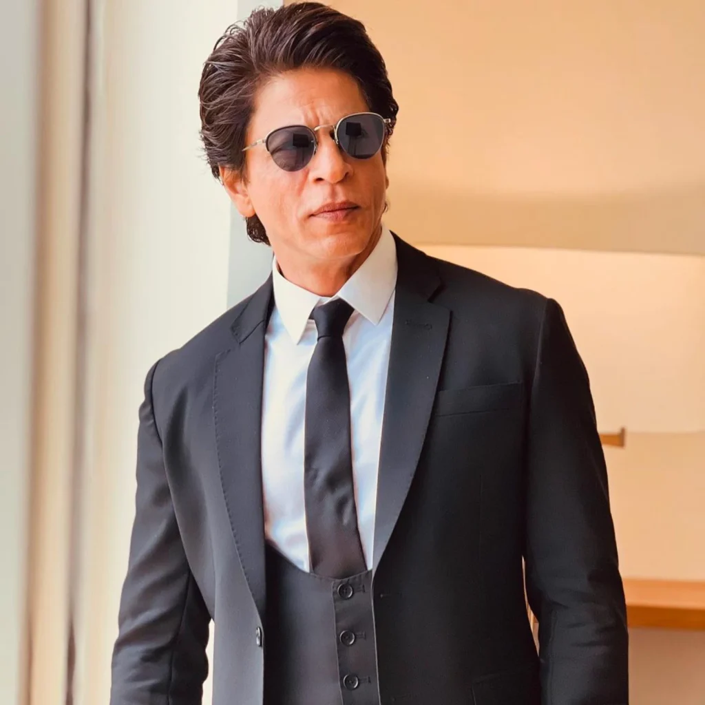 Shahrukh Khan in blue suit and white shirt with matching tie and goggles - indian celebrities who have done lasik