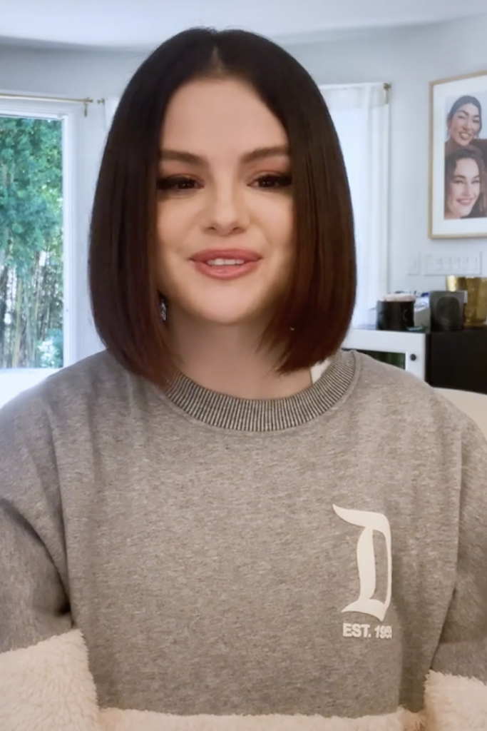 selena gomez in grey round neck top smiling and posing for camera and showing her blunt bob haircut - selena gomez short hair