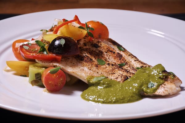 Halibut with Sweet Potato Puree and Chimichurri serves in a white plate - bodybuilding dinner meal