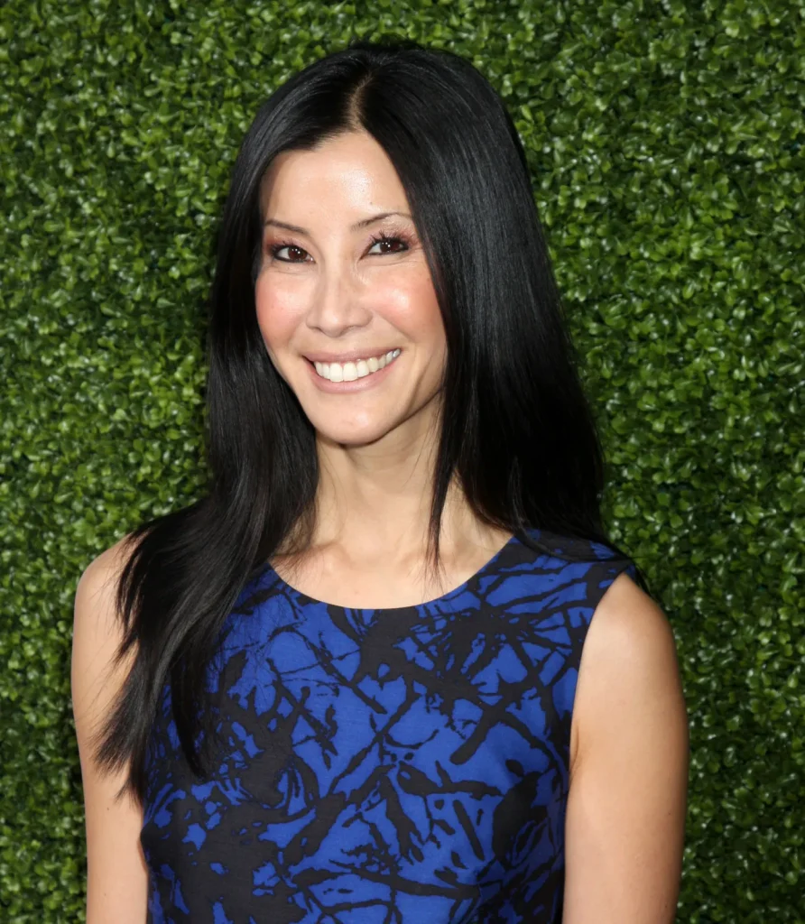Smiling Lisa Ling blue and black cut sleeves top posing for camera - celebrities who got lasik surgery