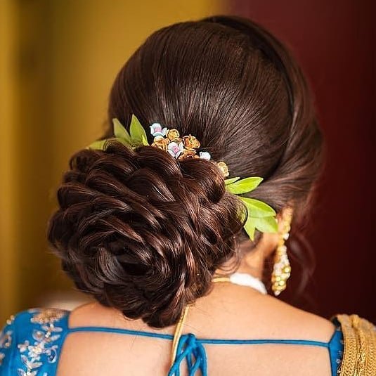 A girl in blue blouse with golden saree posing for camera and showing the back view of her Rose Structured Bun - bun hairstyles