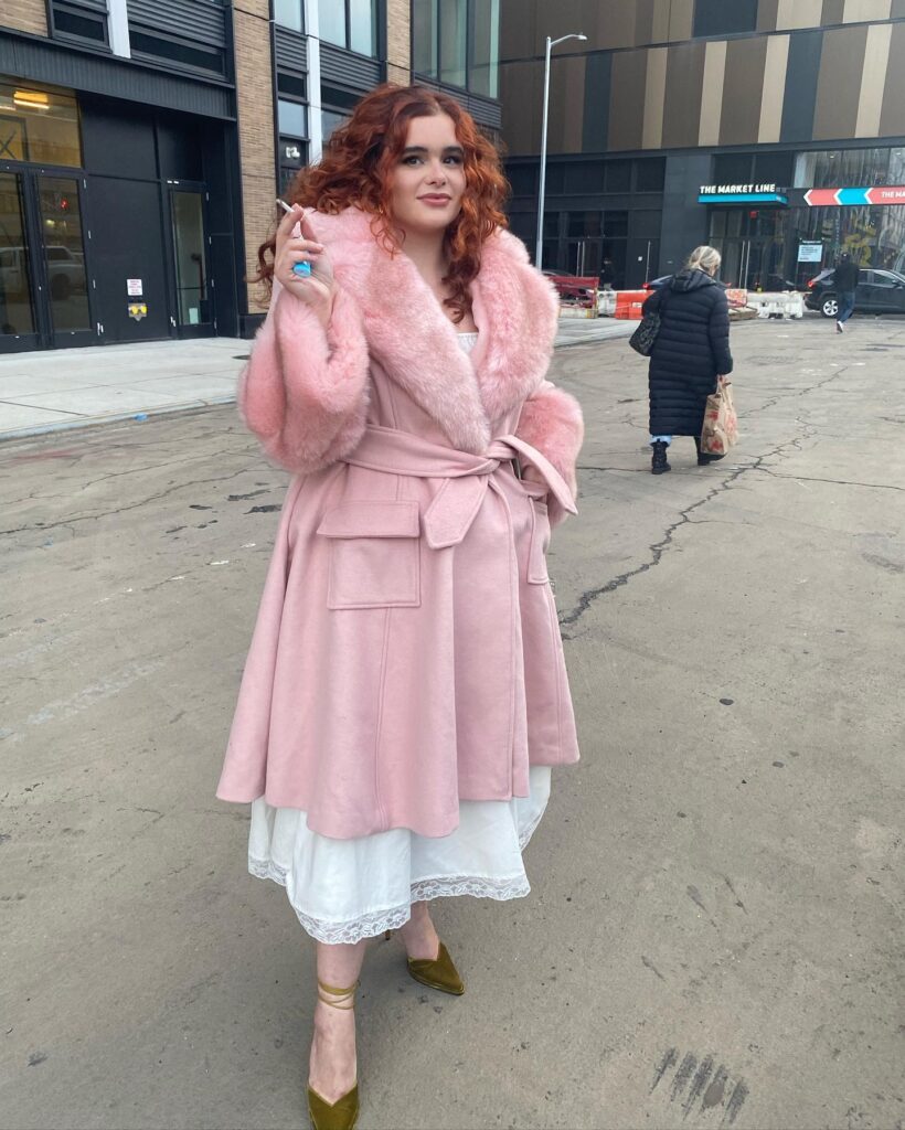 Barbie Ferreira in pink fur outfit holding a cigarette and posing for camera and showing her shoulder-length bob - actresses hairstyles