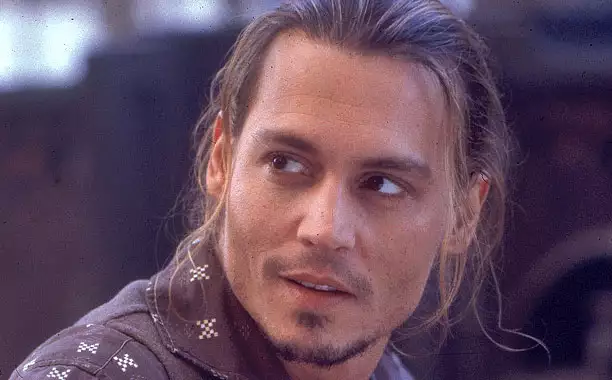 Smiling Johnny Depp in brown shirt posing for camera and showing his Chocolat hairstyle - Johnny Depp hairstyles trending
