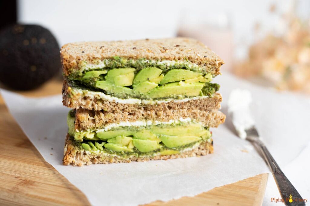 Avocado guacamole sandwich served in a white plate -  breakfast for muscle gain and fat lose