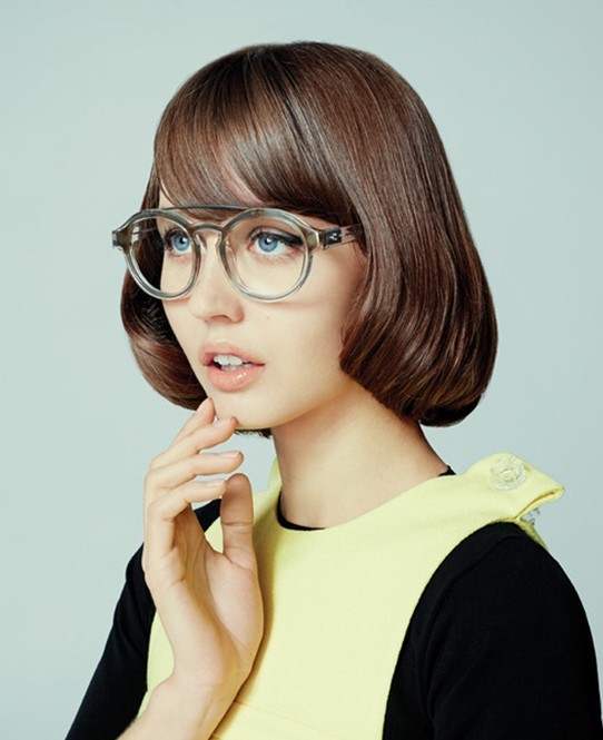 A girl in yellow and black dress with round spectacles showing her Round Edges hairstyle - short hair cuts fir girls 