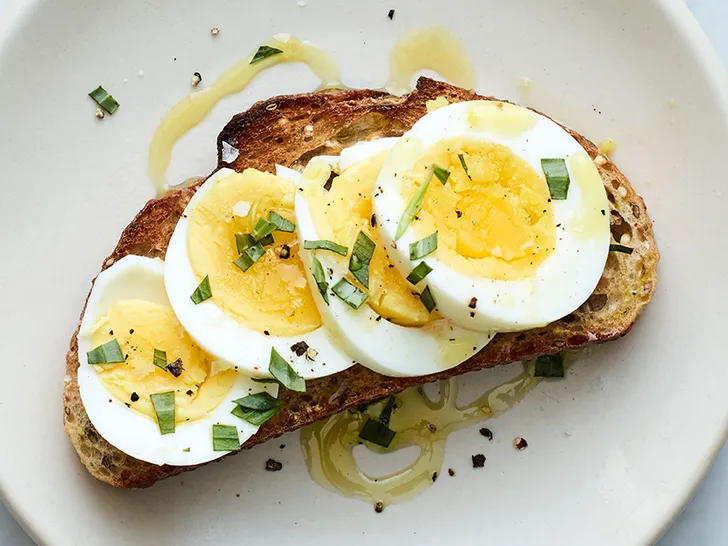 Hard-Boiled Eggs and Ezekiel Bread in a white plate - diet for body building
