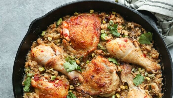Harissa Chicken & Moroccan Couscous served in a black pan - diet for bodybuilding