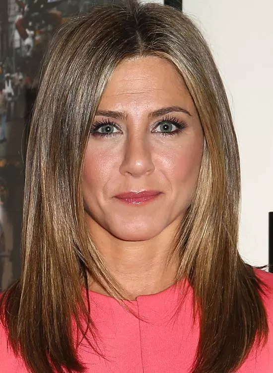 Jennifer Anniston in pink dress posing for camera and showing her Naturally Wavy hair - hairstyles of bollywood actresses