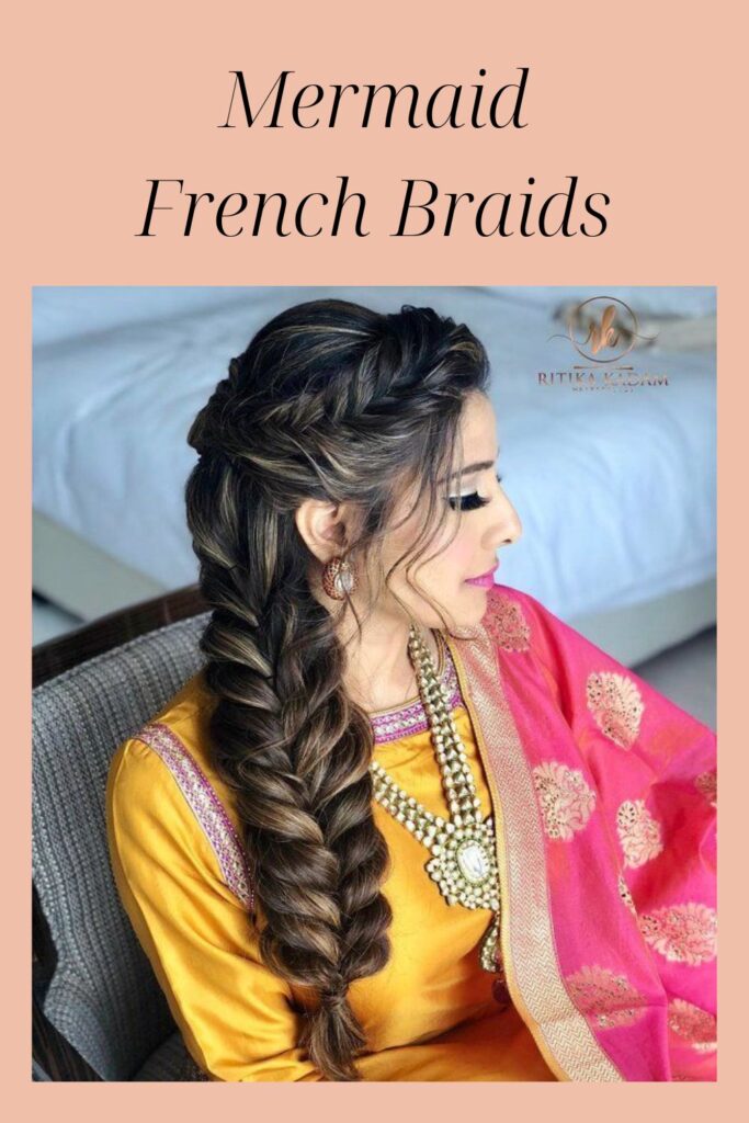 A women in red and pink traditional suit with jewellery showing her Mermaid French Braids - Indian Hairstyles 2022 