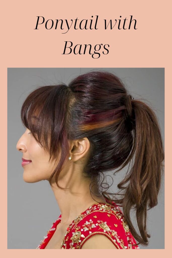 A girl in red outfit showing the side view of her Ponytail with Bangs hairstyle - 2022 hairstyles for Indian Women
