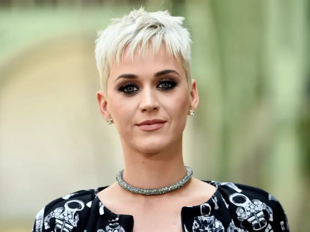 Katy Perry in black and white dress with necklace posing for camera - hollywood short hair actress