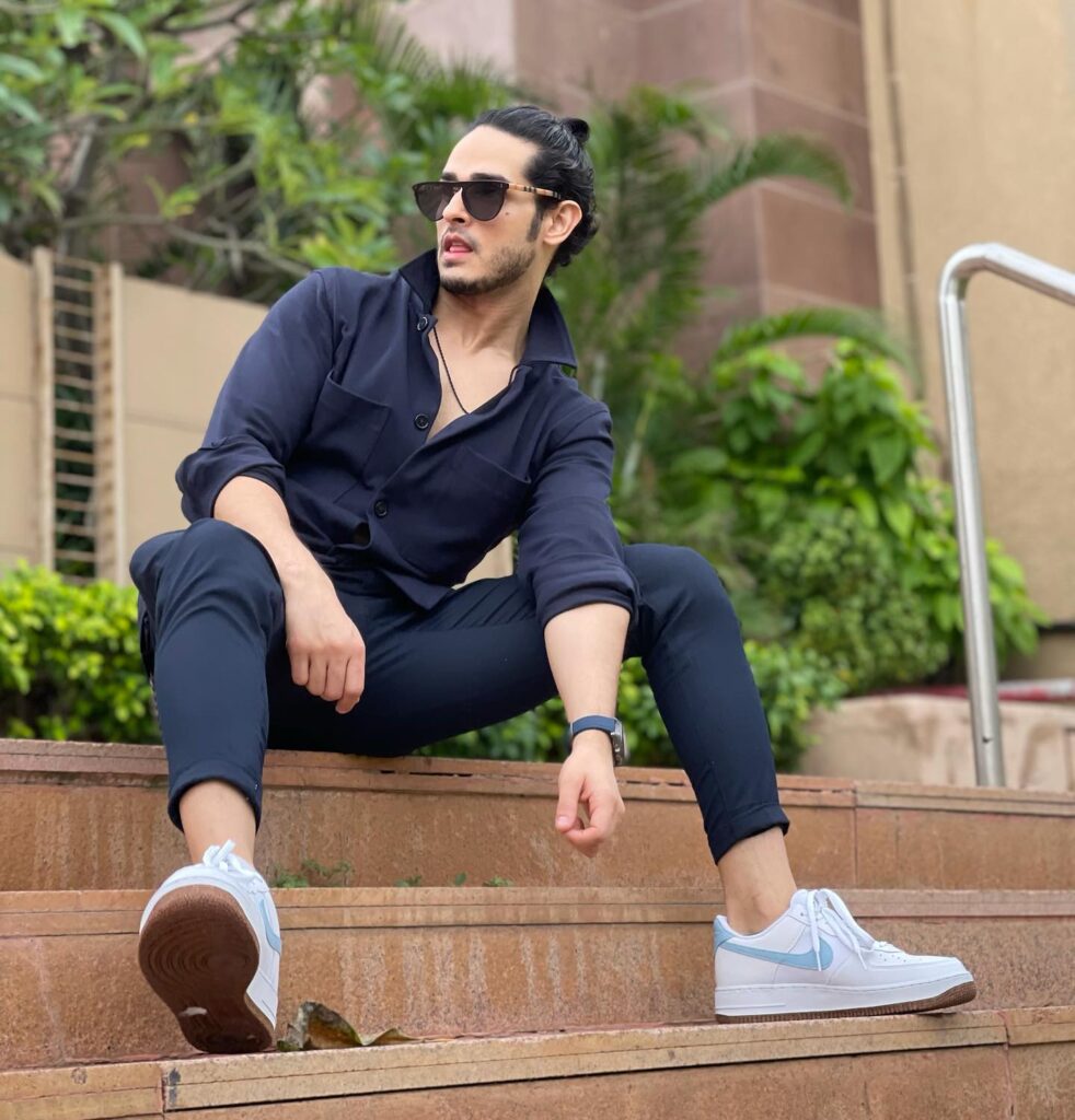 Priyank Sharma in all blue outfit with white sneakers and goggles posing for camera - top 10 hindi serial actors 2022