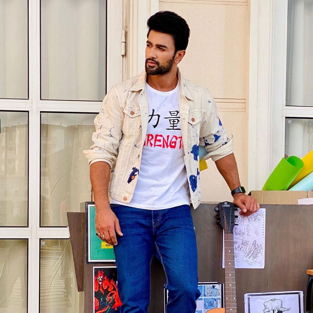 Nishant Malkhani in blue jeans with white t-shirt and multi color printed jacket posing for camera - top 10 hindi serial actors 2022