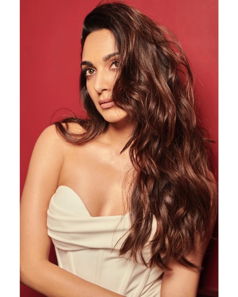 Kiara Advani in off shoulder white dress posing for camera - Bollywood actresses hairstyles