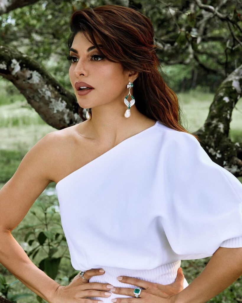 Jacqueline Fernandez in white dress with white drop earrings posing for camera - India beautiful girls 2022