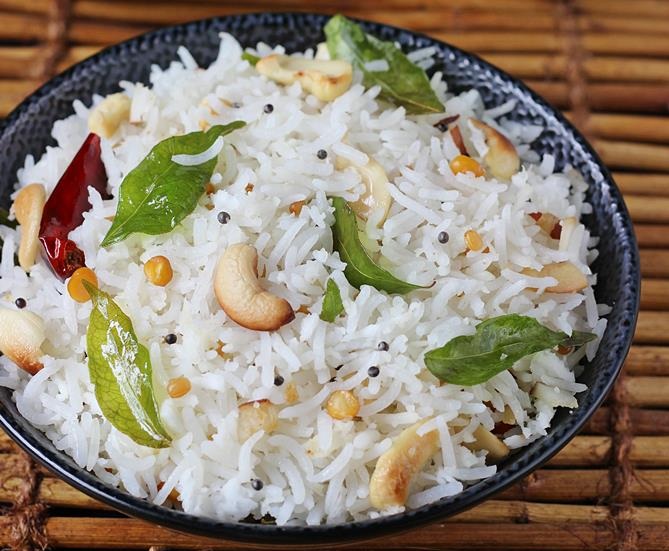 Coconut Cashew Rice served in a black bowl with curry leaves - bodybuilder vegetarian diet plan